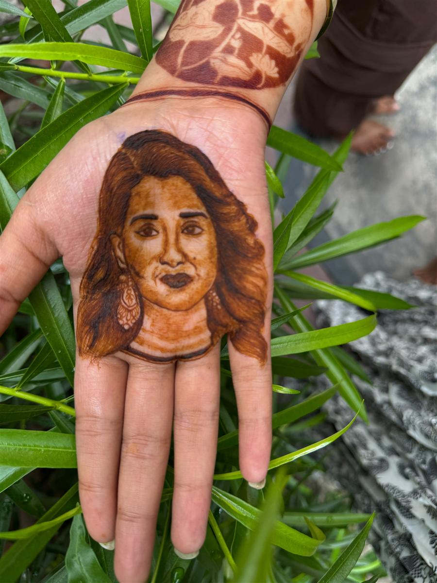 Realistic woman's portrait in henna on a palm