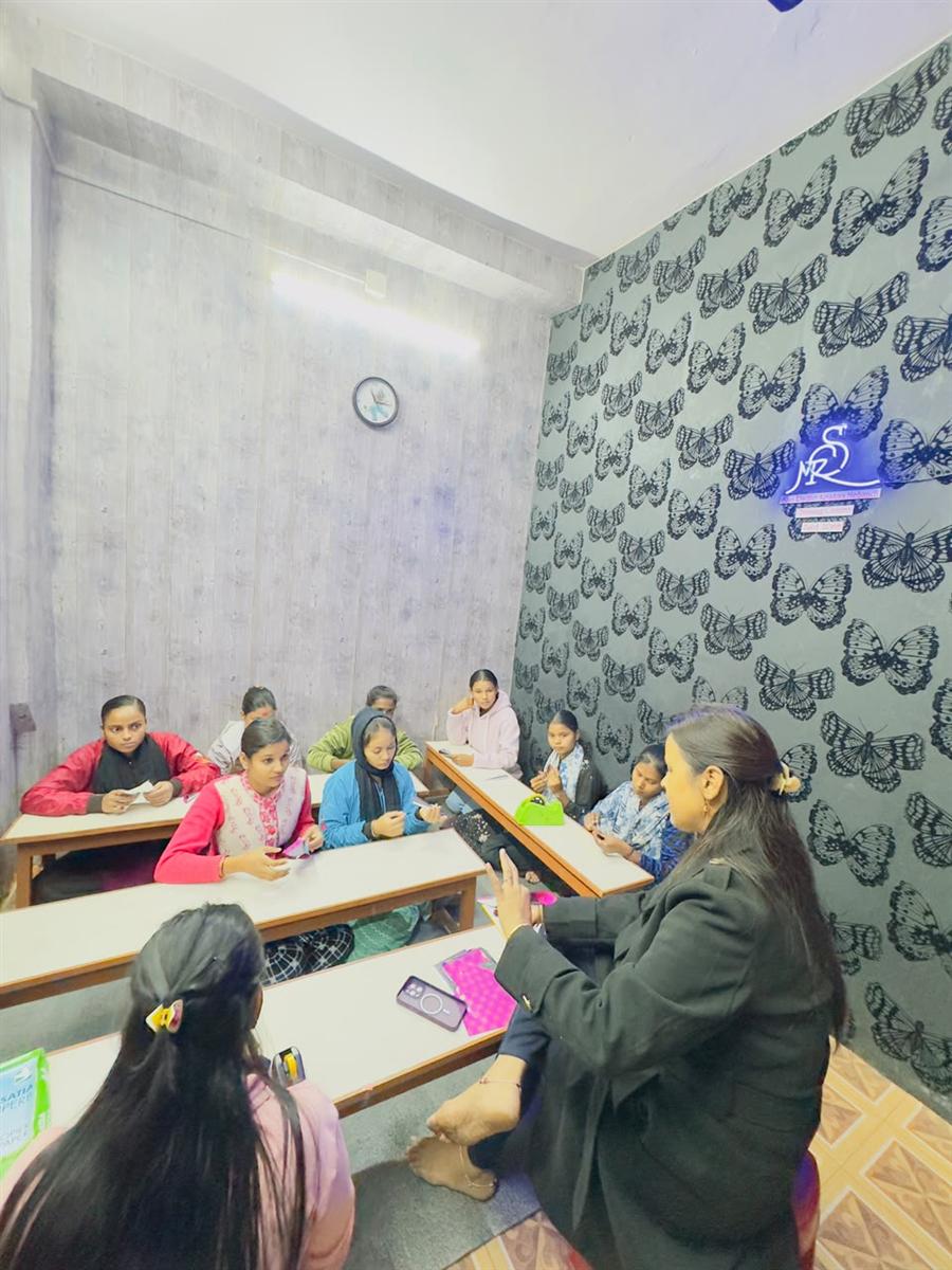 Class in the studio with neon butterfly wall