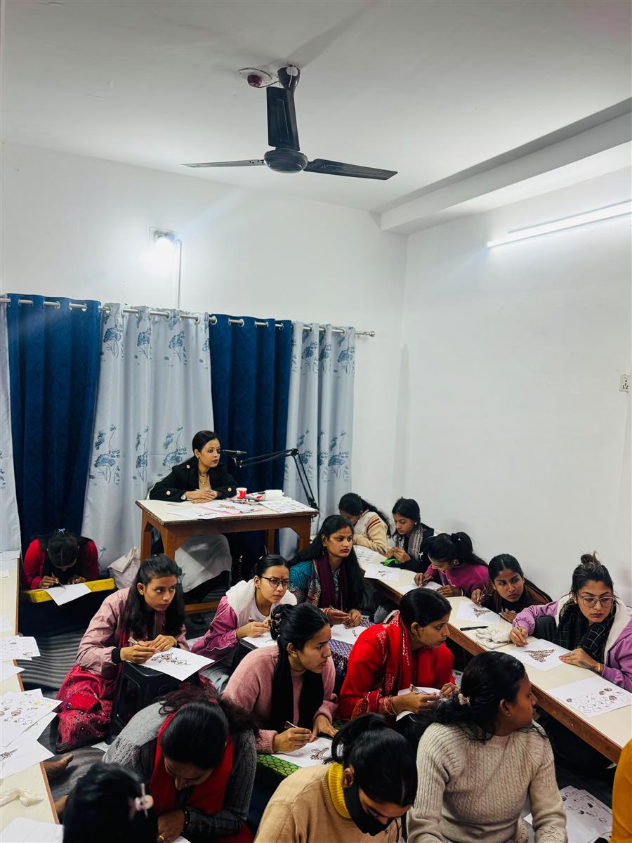 Students practising mehandi designs on paper sketchbooks